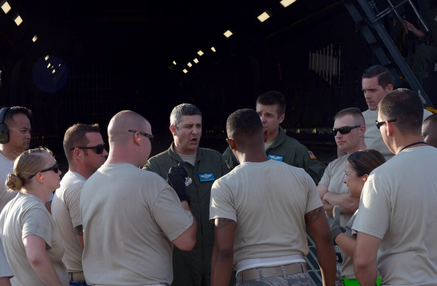 U.S. Air Force Master Sgt. Jeff Stanley, a load master with the 9th Airlift Squadron at Dover Air Force Base (AFB), Del., provides Airmen a mission safety brief at Ellsworth AFB, S.D., Aug. 2, 2016. Approximately 650 tons of equipment is being transported to Andersen AFB, Guam, in support of the continuous bomber presence mission. (U.S. Air Force photo by Airman Donald Knechtel)