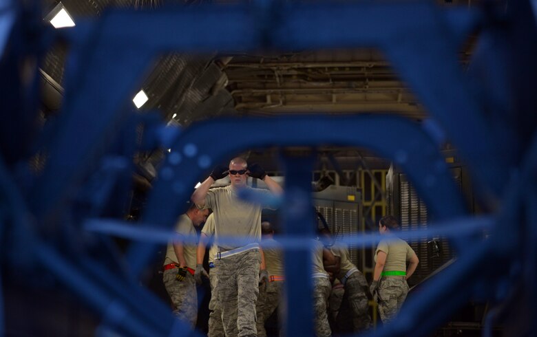 Airmen with the 28th Aircraft Maintenance Squadron load equipment onto a Dover Air Force Base (AFB), Del., C-5 Galaxy at Ellsworth AFB, S.D., Aug. 2, 2016. C-5’s and 747’s are transporting 650 tons of equipment to Guam in support of U.S. Pacific Command’s continuous bomber presence mission where Ellsworth’s B-1 bombers will provide the command with a credible, strategic power projection platform. (U.S. Air Force photo by Airman Donald Knechtel) 