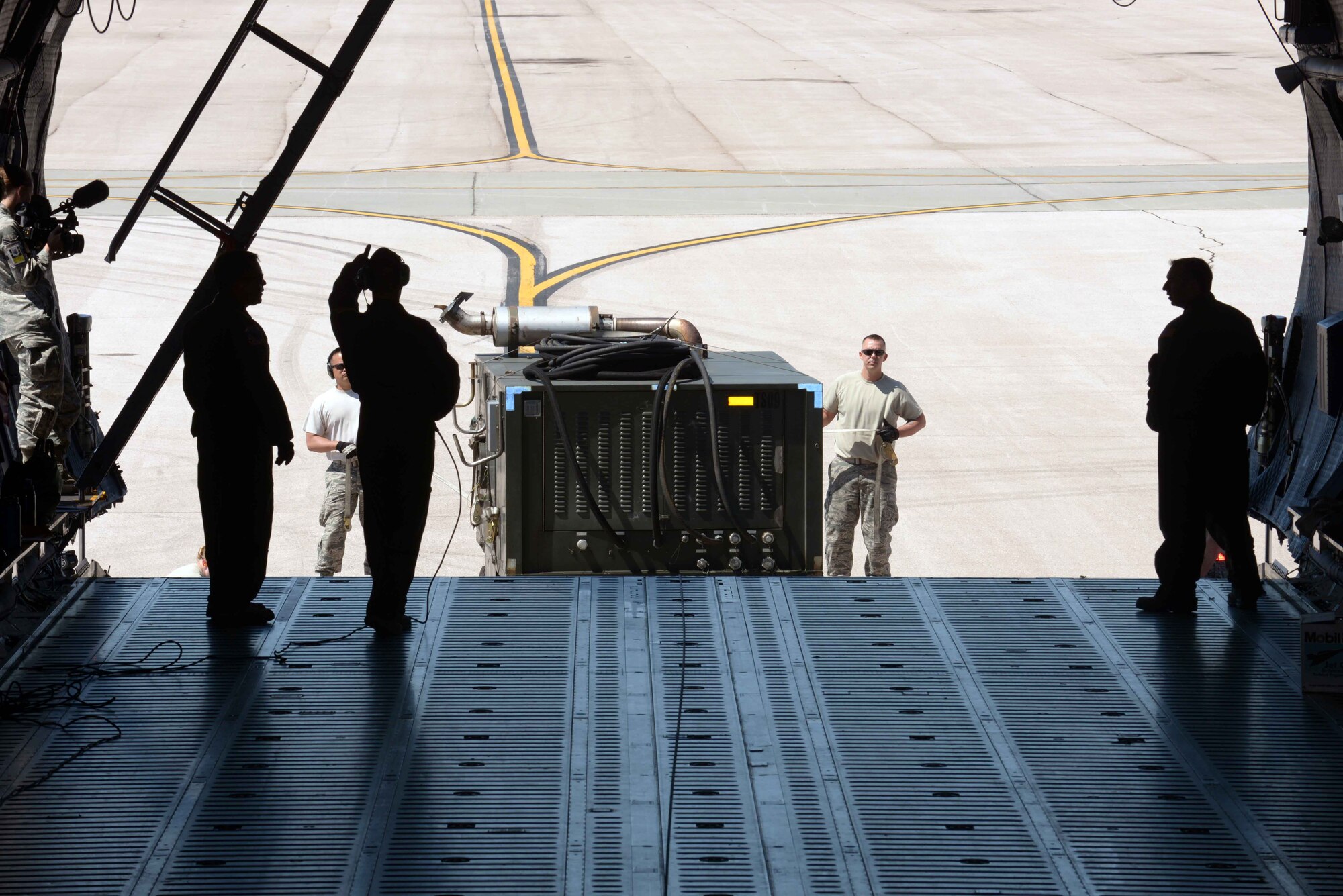 Airmen with the 28th Aircraft Maintenance Squadron load equipment into a C-5 Galaxy from Travis Air Force Base (AFB), Calif., at Ellsworth AFB, S.D., Aug. 4, 2016. The equipment is being transported from Ellsworth AFB to Andersen AFB, Guam, where it will be used to support B-1 bombers as they provide U.S. Pacific Command a global strike and extended deterrence capability. (U.S. Air Force photo by Airman Donald Knechtel) 