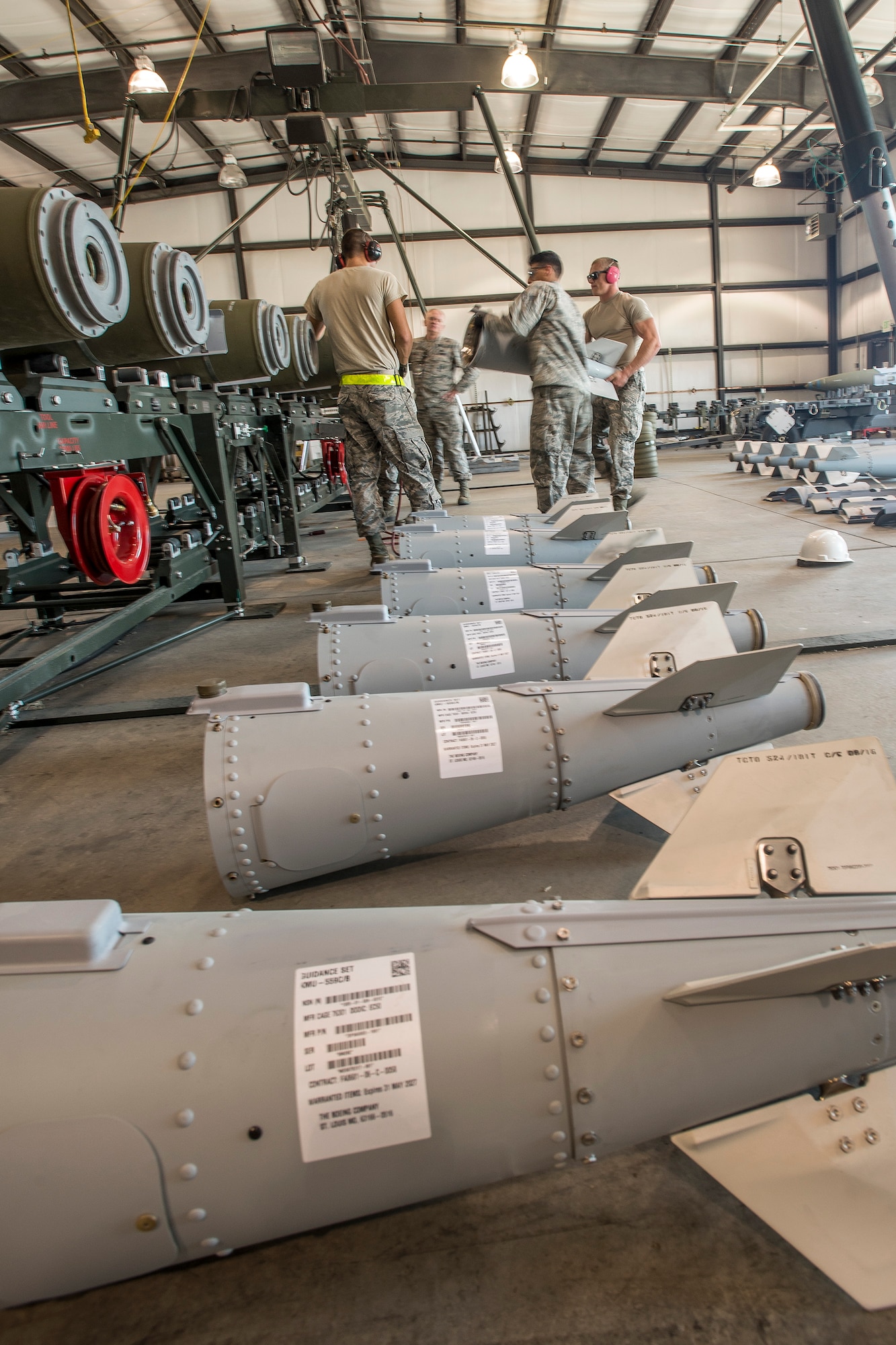 Airmen from the 325th Maintenance Squadron, Tyndall Air Force Base, Fla., lift a GBU-32 bomb tail section onto the primary bomb body Aug. 2 at Hill AFB, Utah. The bombs being assembled will be dropped later by aircraft participating in exercise Combat Hammer at Hill AFB and the Utah Test and Training Range. (U.S. Air Force photo by Paul Holcomb)
