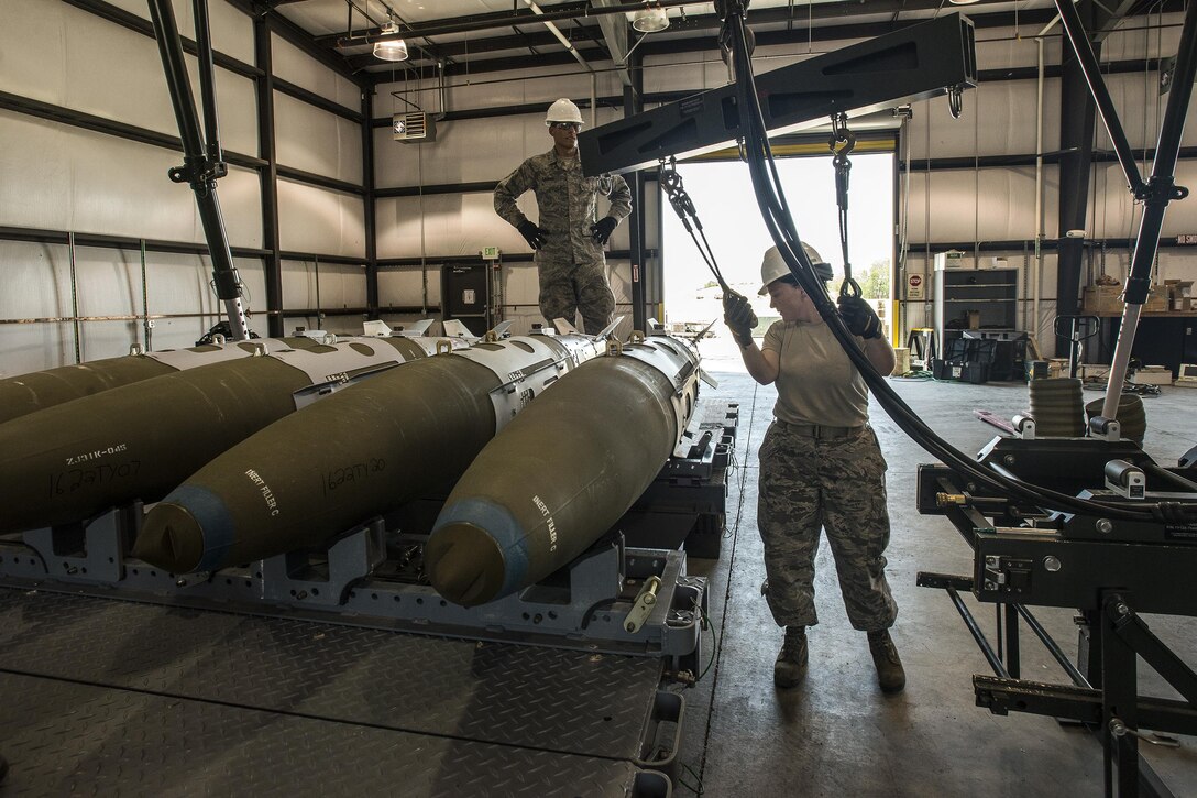 Staff Sgt. Kimber Bergstrom, 325th Maintenance Squadron, Tyndall Air Force Base, Fla., moves a hoist apparatus after loading GBU-32 bombs onto a trailer Aug. 2 at Hill AFB. The bombs will be used later during Combat Hammer, an exercise currently taking place at Hill AFB and the Utah Test and Training Range. (U.S. Air Force photo by Paul Holcomb)