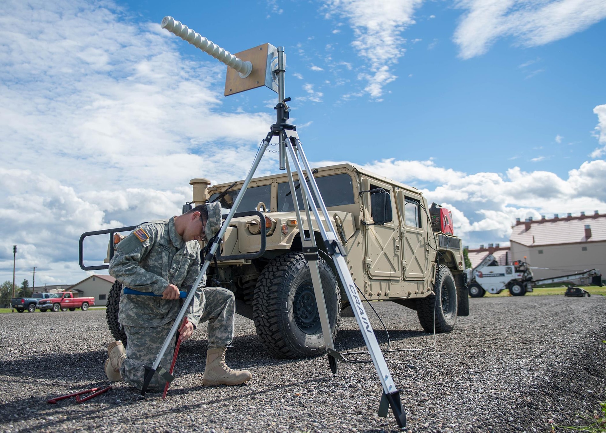U.S. Army Spc. Angel Mendoza, 4th Space Company, 1st Battalion, 1st Space Brigade, assigned as a space aggressor operator to the 527th Space Aggressor Squadron, Schreiver Air Force Base, Colo., secures a helical antenna to a gravel pad adjacent to the flight line Aug. 8, 2016, during RED FLAG-Alaska (RF-A) 16-3, at Eielson Air Force Base, Alaska. Along with two modems and an amplifier, space aggressors at RF-A 16-3 interrupt GPS systems for navigation and weapons, which pilots use during the exercise designed to simulate the first 10 combat sorties of a surge operation or conflict. (U.S. Air Force photo by Staff Sgt. Shawn Nickel)