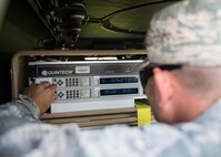 U.S. Air Force Capt. Dustyn Carroll, the 527th Space Aggressor Squadron (SAS) adversary training flight commander assigned to Schreiver Air Force Base, Colo., changes the frequency on two modems to interrupt GPS systems on aircraft Aug. 8, 2016, during RED FLAG-Alaska (RF-A) 16-3, at Eielson Air Force Base, Alaska. The capabilities the space aggressors bring to RF-A 16-3 enables joint and international units to sharpen their combat skills by creating a realistic threat environment. (U.S. Air Force photo by Staff Sgt. Shawn Nickel)