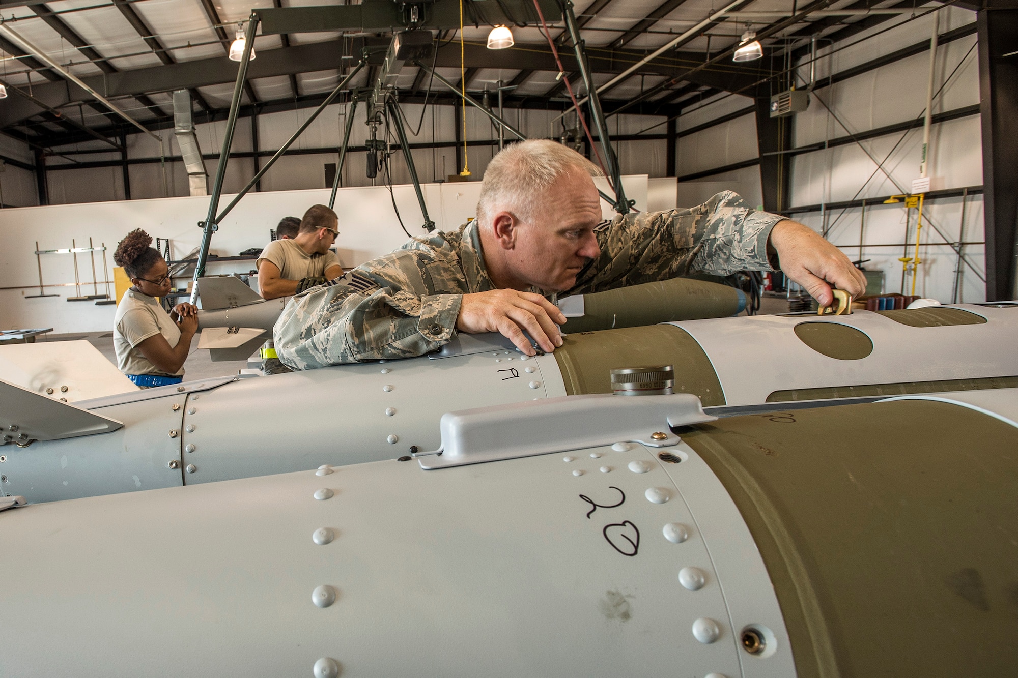 Tech Sgt. Anthony Mansell, an ammo evaluator with the 86th Fighter Weapons Squadron, checks the lugs on a GBU-32 bomb Aug. 2 at Hill AFB, Utah. The bombs will be dropped at the Utah Test and Training Range during the air-to-ground exercise known as Combat Hammer. Combat Hammer tests precision weapons for performance and suitability for combat. (U.S. Air Force photo by Paul Holcomb)