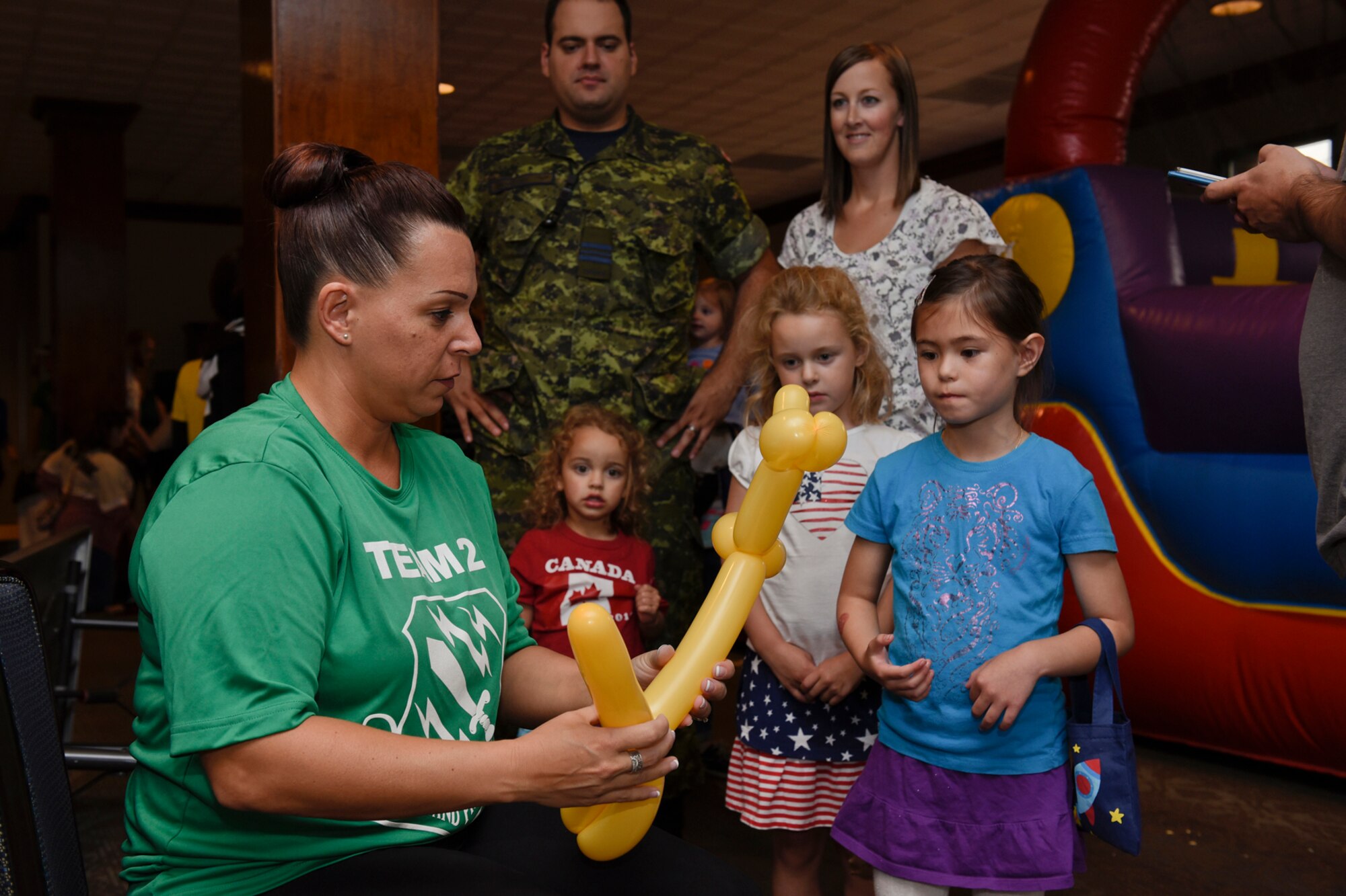 Chief Master Sgt. Kristine Jones, 21st Operations Group superintendent, twists together a balloon animal for a line of Airmen and their families at the Family Festival at The Club on Peterson Air Force Base, Colo., Aug. 6, 2016. The event was put on by the 21st Force Support Squadron and was free and open to anyone with base access. (U.S. Air Force photo by Senior Airman Rose Gudex)