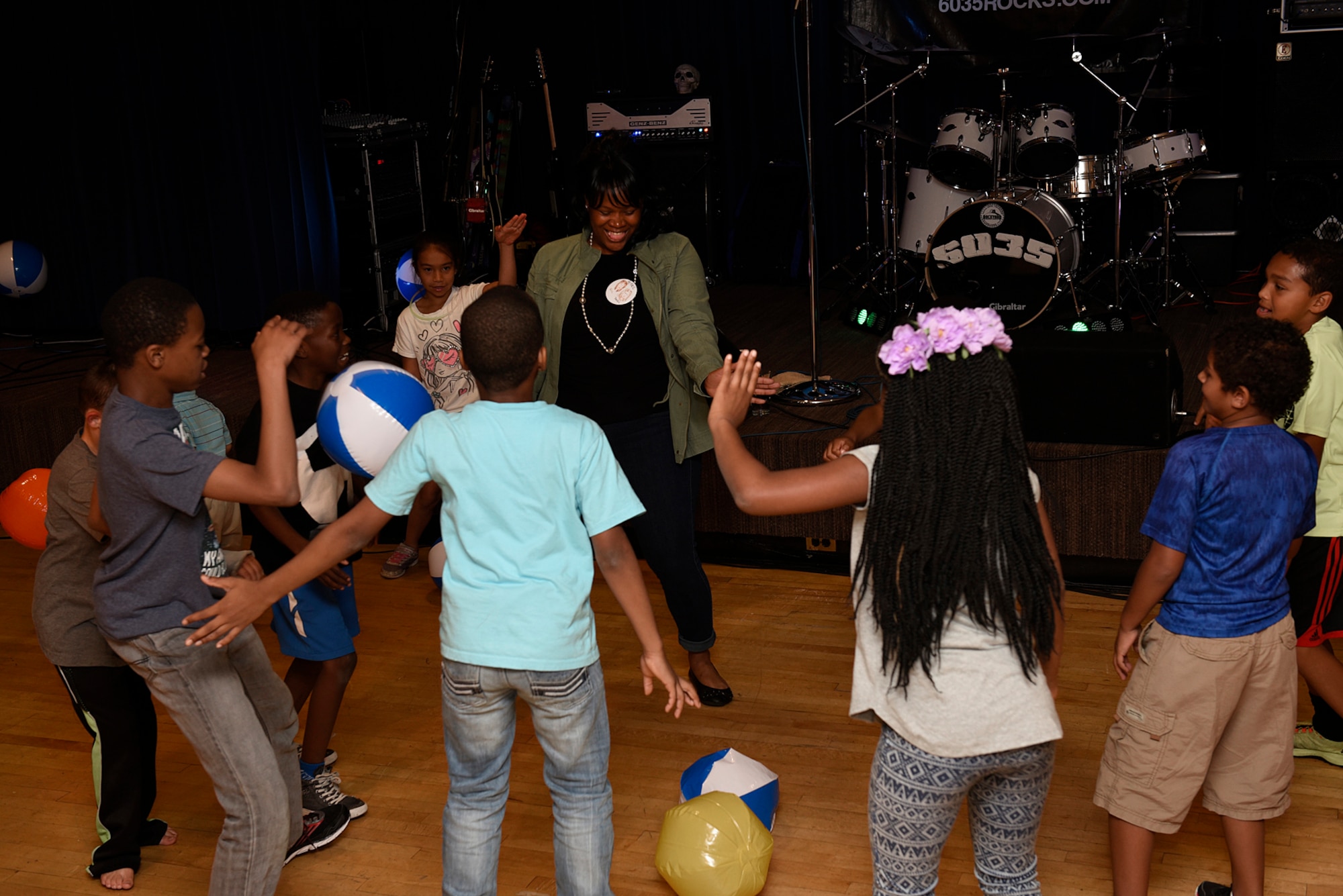 Tech. Sgt. Kristal Coleman, 21st Force Support Squadron force management section chief, dances in the middle of a group of Team Pete youth at the Family Festival and Concert at The Club on Peterson Air Force Base, Colo., Aug. 6, 2016. The event was free and open to anyone with base access and included music from rock band 6035. (U.S. Air Force photo by Senior Airman Rose Gudex)