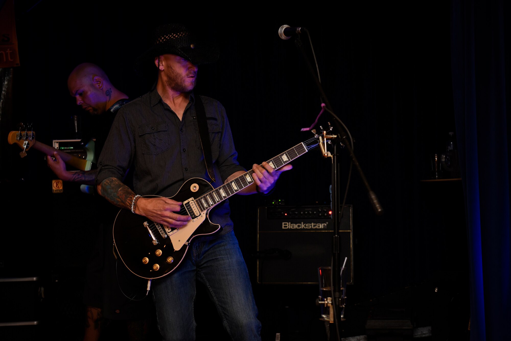 A member of the rock band 6035 jams on his guitar at the Family Festival and Concert at The Club on Peterson Air Force Base, Colo., Aug. 6, 2016. The group performed music throughout the event that also included face painting, a bouncy obstacle course, carpet bowling, other games and family-friendly fun to anyone with base access. (U.S. Air Force photo by Senior Airman Rose Gudex)