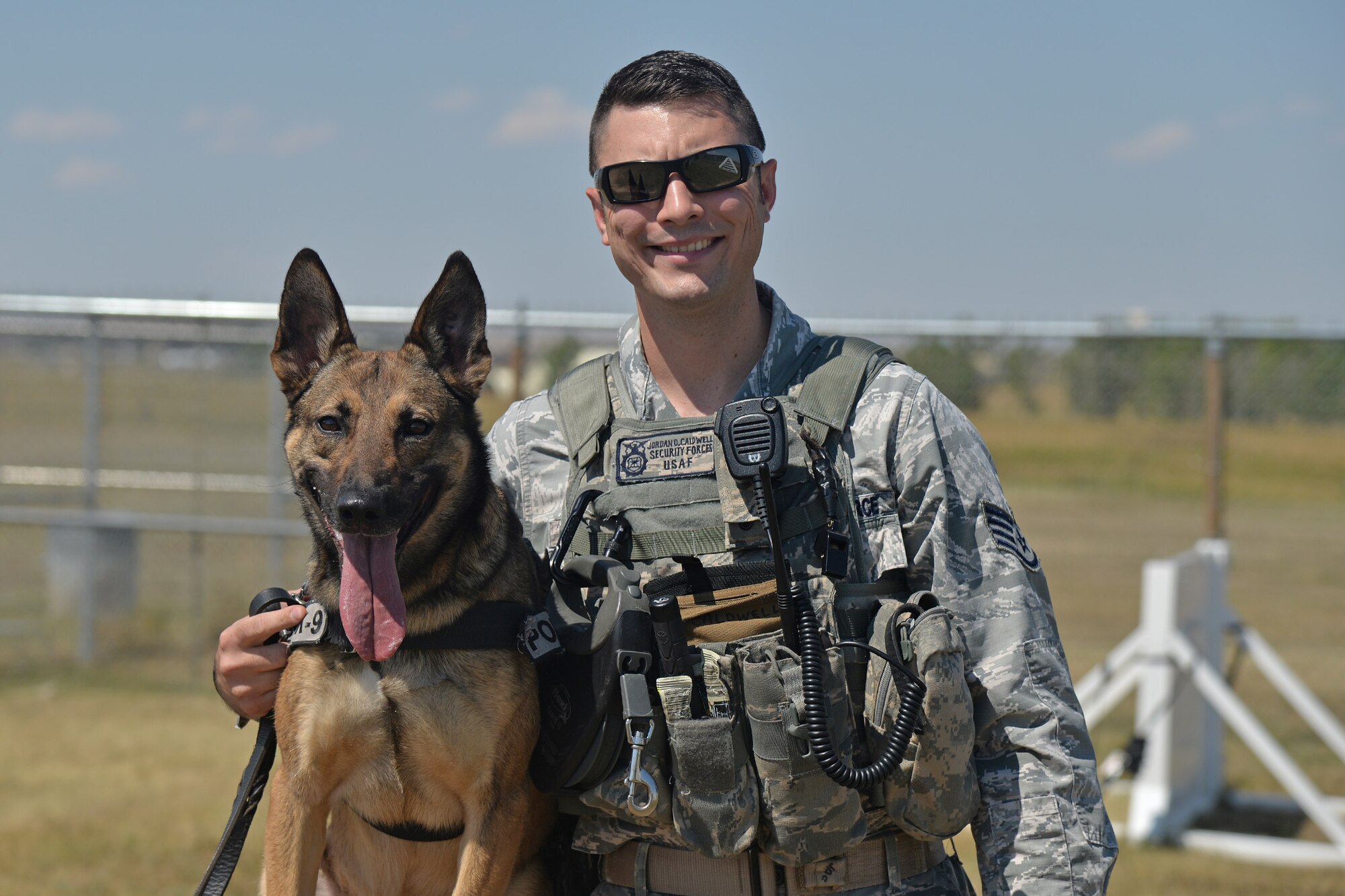 Staff Sgt. Jordan Caldwell, 341st Security Forces Squadron military working dog handler, poses with his K-9 Lady during training Aug. 8, 2016, at Malmstrom Air Force Base, Mont. Caldwell and Lady served as a detection team during the Republican and Democratic National Conventions. (U.S. Air Force photo/Airman 1st Class Daniel Brosam)