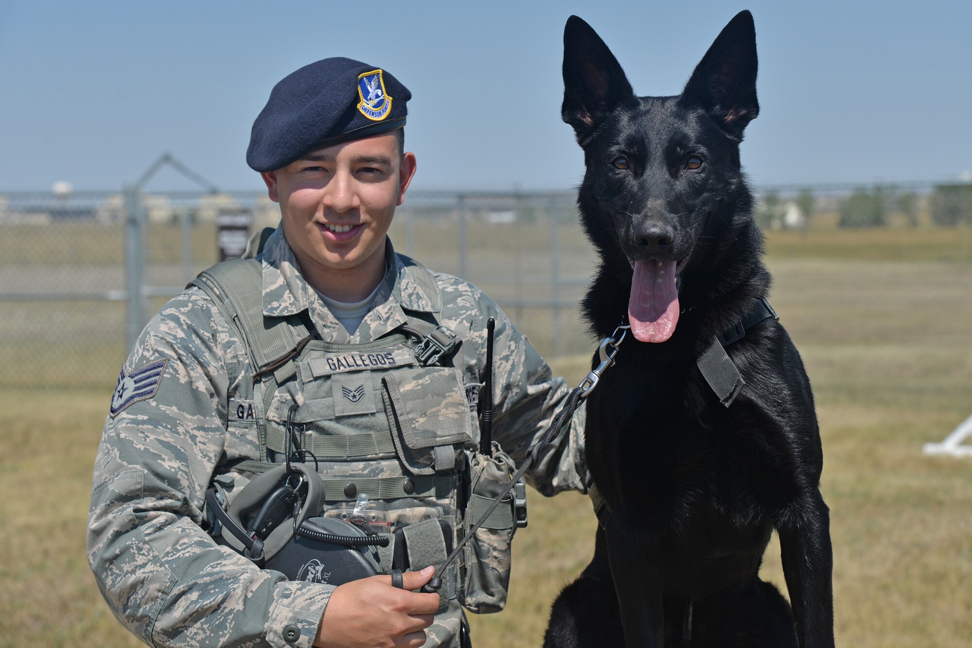 Staff Sgt. Antonio Gallegos, 341st Security Forces Squadron military working dog handler, poses with his K-9 companion Eric during training Aug. 8, 2016, at Malmstrom Air Force Base, Mont. Gallegos and Eric served as a detection team during both the Republican and Democratic National Conventions. (U.S. Air Force photo/Airman 1st Class Daniel Brosam)