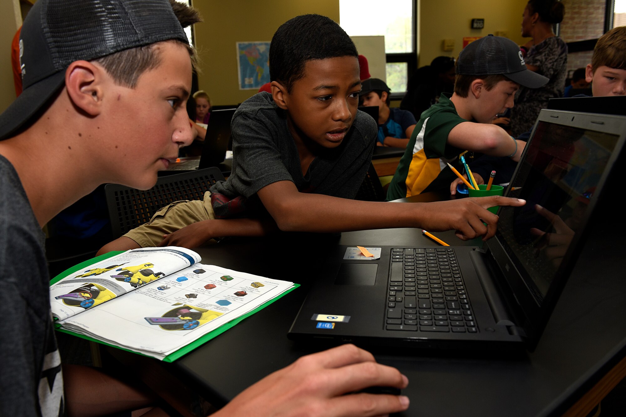 Jared Stiller, 13, and Ajeante’ Sumpter, 12, work together on a submarine engineering project at a STEM Camp at Peterson Air Force Base, Colo., Aug. 4, 2016. The camp taught science, technology, engineering and mathematics to students from around the country in a hand-on learning environment over the course of one week. (U.S. Air Force photo by Senior Airman Rose Gudex)
 
