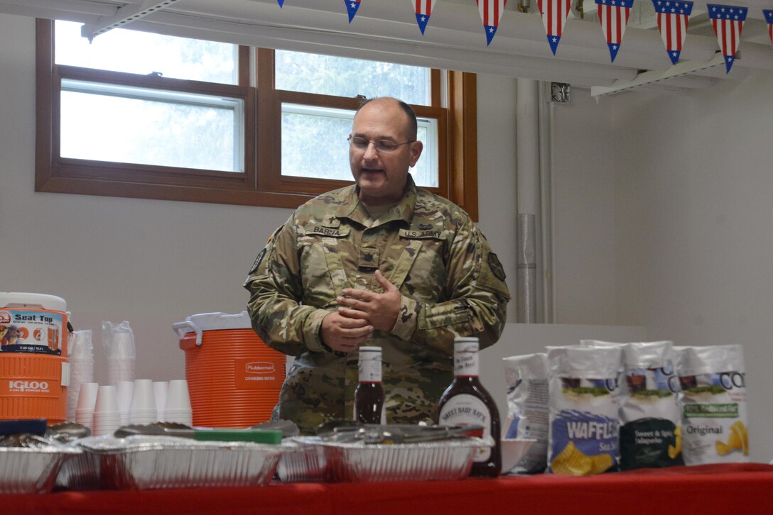 Army Lt. Col. Charles Barna, 673d ABW chaplain, says a prayer before eating at the Arctic Warrior Chapel reopening at Joint Base Elmendorf-Richardson, Alaska, Aug. 5, 2016. The renovations started in February to improve safety and upgrade the facility to support religious services and military functions. (U.S. Air Force photo by Airman 1st Class Christopher R. Morales)