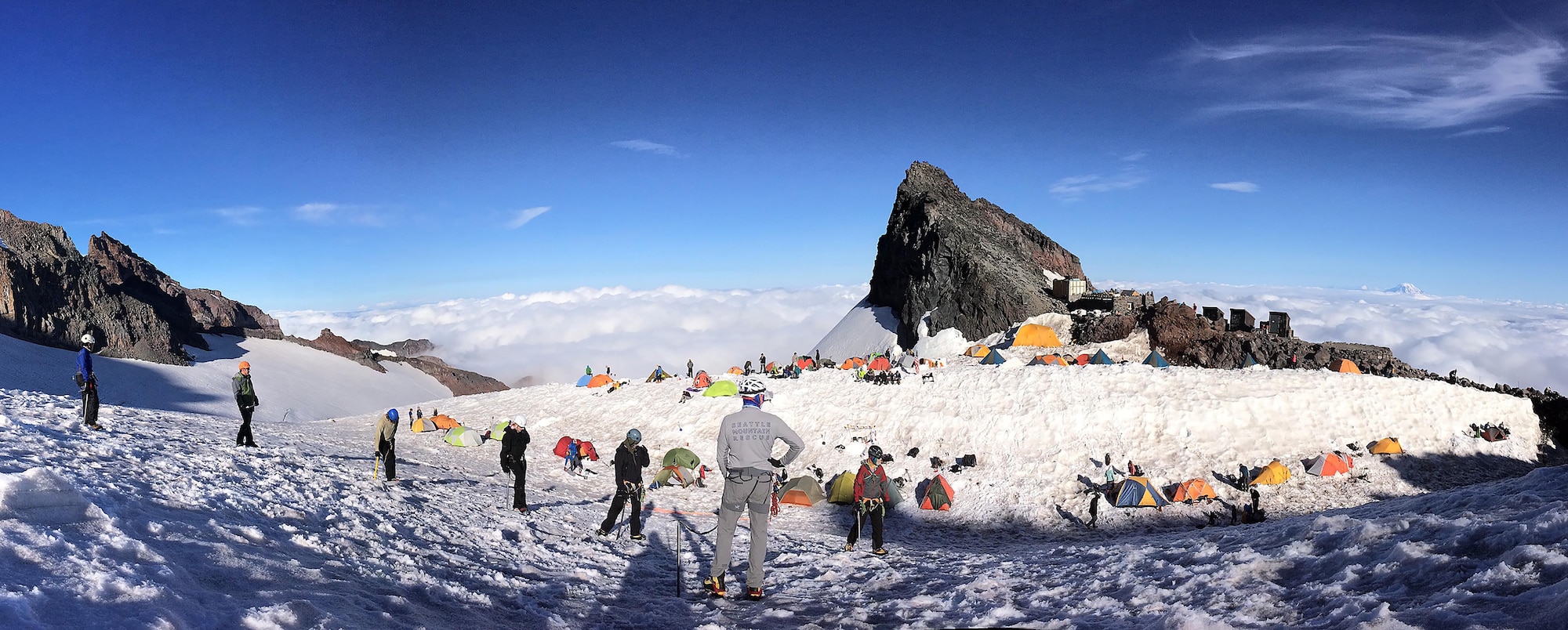 A Seattle Mountain Rescue member (center), instructs members of the U.S. Air Force 50 Summits Challenge on climbing safety July 22, 2016, at Camp Muir, Mount Rainier, Wash. To summit the mountain, climbers were shown how to safely cross crevasses and properly use ice axes and crampons. (U.S. Air Force photo/Maj. Rob Marshal) 