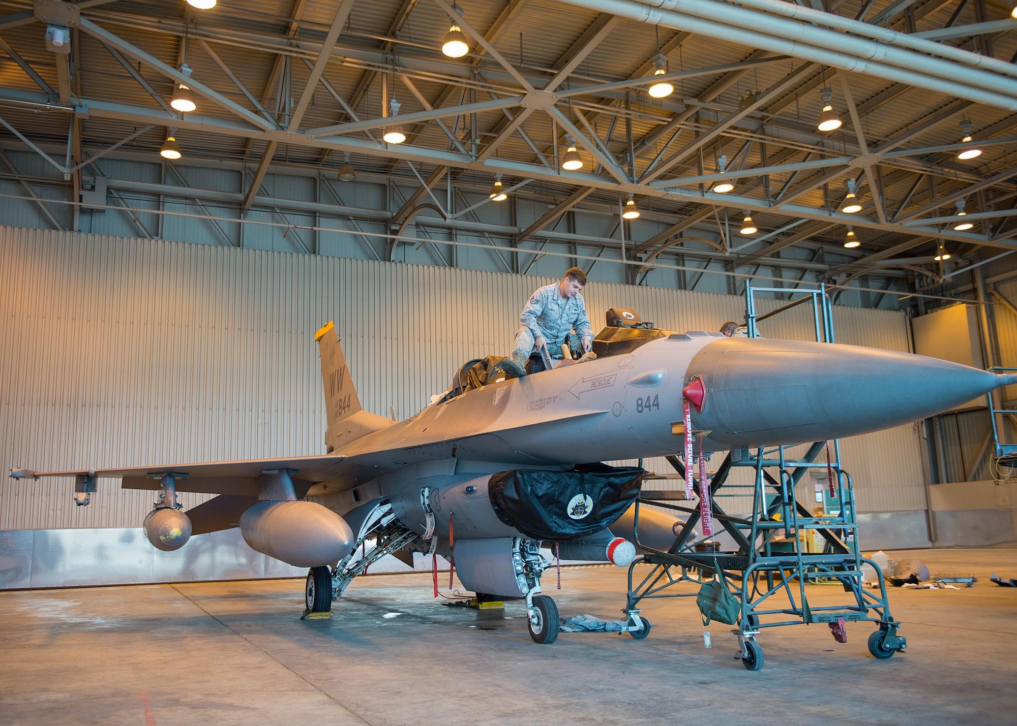 U.S. Air Force Staff Sgt. Corey Holt, an aircrew egress systems craftsman assigned to the 35th Maintenance Squadron, Misawa Air Base, Japan, holds an ejection seat still in an F-16D Fighting Falcon aircraft while Staff Sgt. Shawn Layou, an aircrew egress systems craftsman assigned to the 8th Maintenance Squadron, Kunsan AB, Republic of Korea, bolts it into place Aug. 9, 2016, during RED FLAG-Alaska (RF-A) 16-3 at Eielson Air Force Base, Alaska. Units from across the Department of Defense and partner nations send units to Eielson for RF-A to train for contingency operations in a controlled environment stressing joint and multinational integration. (U.S. Air Force photo by Staff Sgt. Shawn Nickel)