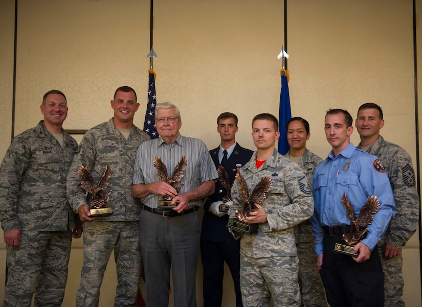 Col. Robert Lyman, Joint Base Charleston commander, left, and Chief Master Sgt. Mark Bronson, 628th Air Base Wing (ABW) command chief, right, stand with the 628th ABW second quarter award winners during a ceremony at the Charleston Club Aug. 5, 2016. The quarterly awards recognize outstanding Airmen, NCOs, senior NCOs, company grade officers and civilians for their hard work and dedication. (U.S. Air Force photo by Airman 1st Class Thomas T. Charlton)