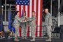 Col. Kristin Streukens, 151st Air Refueling Wing Commander, hands a musket to Chief Master Sgt. Matthew Hooper, 151st Air Refueling Wing Command Chief, during a transfer of responsibility ceremony on Aug. 7, 2016, at the Roland R. Wright Air National Guard Base in Salt Lake City. The musket, representing the historic minuteman roots of the National Guard, was passed from the Wing's outgoing command chief, Chief Master Sgt. Barry Vance to Hooper through Streukens. (U.S. Air National Guard photo by Staff Sgt. Annie Edwards)