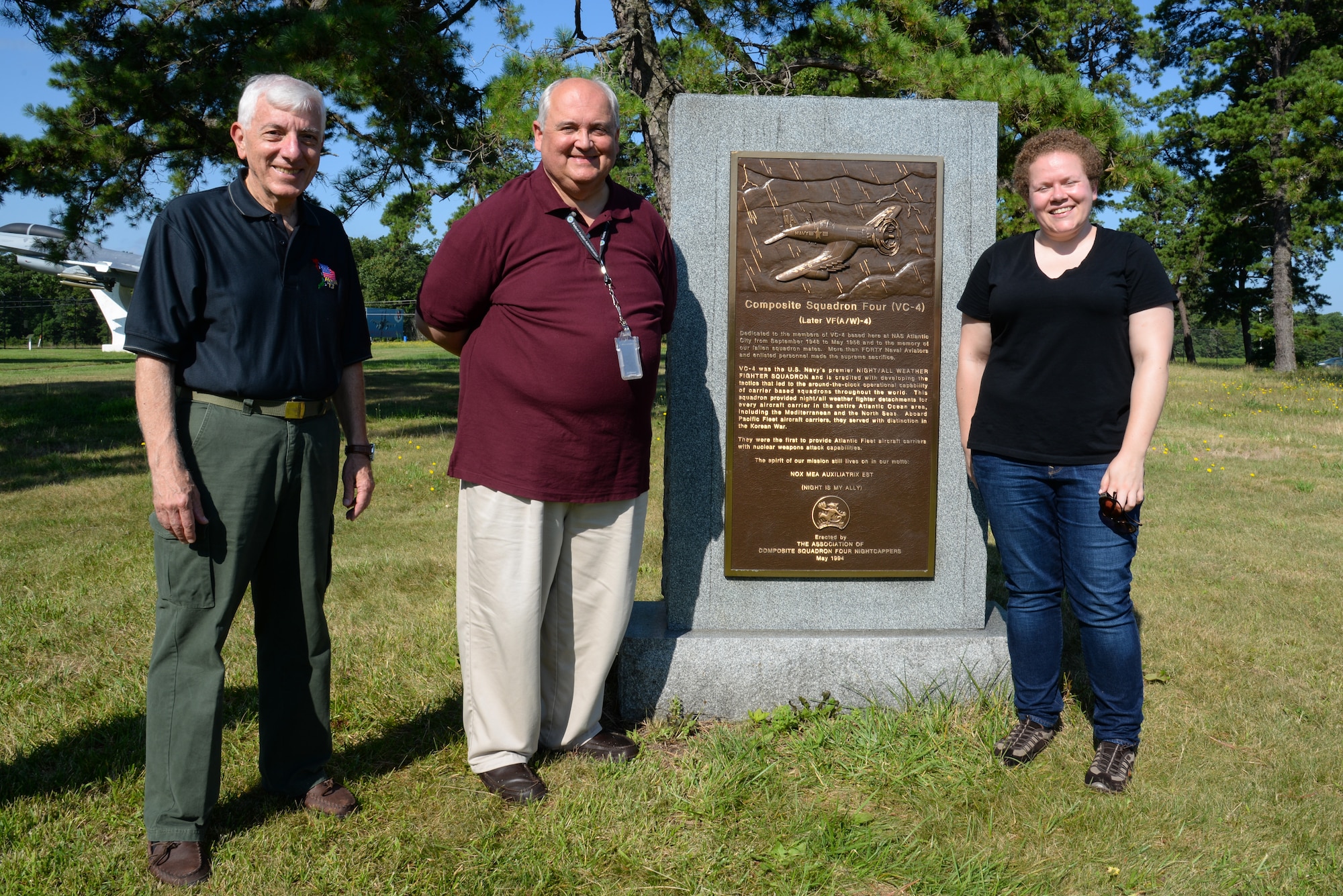 A picture of Melissa Swanson, Naval History and Heritage Command Conservator, Stan Ciurczak, Management and Program Analyst with the FAA William J. Hughes Technical Center, and Dr. Richard Porcelli, local aviation historian, posing for a photo in front of a U.S. Navy VC-4 memorial marker.