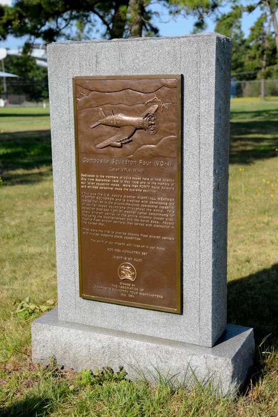 Freshly cleaned and polished, a U.S. Navy VC-4 memorial marker dries in the sunlight near the main gate of the 177th Fighter Wing of the New Jersey Air National Guard in Egg Harbor Township, N.J., on July 21, 2016. The monument, erected in May 1994 by the Association of The Composite Squadron Four Nightcappers, pays tribute to the members of the VC-4 Squadron based at Naval Air Station Atlantic City from September 1948 to May 1958 who gave the ultimate sacrifice. Melissa Swanson, Naval History and Heritage Command Conservator, based out of Richmond, Virginia, removed lichens growing on the sides and back of the stone monument and polished the bronze plaque. (U.S. Air National Guard photo by Master Sgt. Andrew J. Moseley/Released)