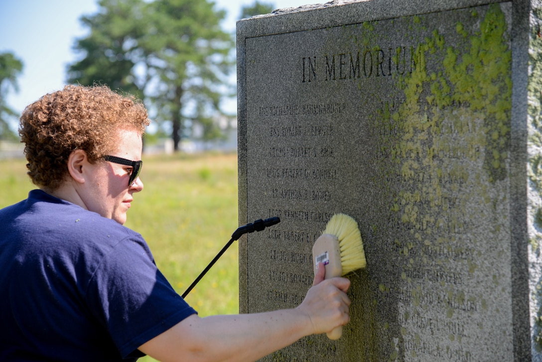 Melissa Swanson, Naval History and Heritage Command Conservator, uses a scrub brush to remove lichens growing on a U.S. Navy VC-4 memorial marker, located near the main gate of the 177th Fighter Wing of the New Jersey Air National Guard in Egg Harbor Township, N.J., on July 20, 2016. The monument, erected in May 1994 by the Association of The Composite Squadron Four Nightcappers, pays tribute to the members of the VC-4 Squadron based at Naval Air Station Atlantic City from September 1948 to May 1958 who gave the ultimate sacrifice. Swanson, based out of Richmond, Virginia, earned an undergraduate degree in art history and anthropology from Wheaton College in Norton, Massachusetts and graduated from Columbia University in New York with a Master’s of Science in Historic Preservation, with a specialty in materials conservation, focusing on working on metals, woods and stone. (U.S. Air National Guard photo by Master Sgt. Andrew J. Moseley/ Released)