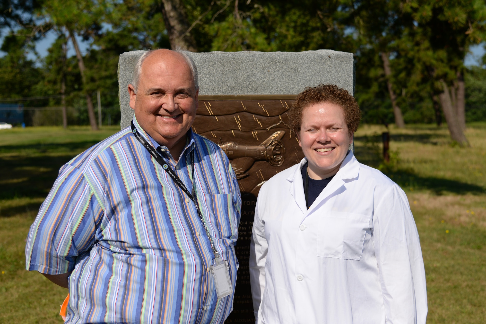 A picture of Stan Ciurczak, Management and Program Analyst with the FAA William J. Hughes Technical Center, and Melissa Swanson, Naval History and Heritage Command Conservator, posing for a photo in front of a U.S. Navy VC-4 memorial marker.
