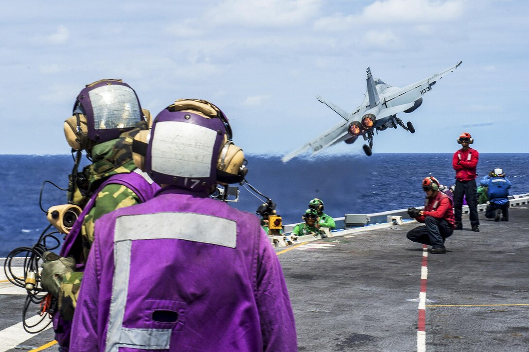 Sailors watch as an F/A-18F Super Hornet launches from the flight deck of the USS John C. Stennis during an air power demonstration in the Pacific Ocean, Aug. 7, 2016. The Stennis provides a combat-ready force to protect collective maritime interests. The Hornet is assigned to Strike Fighter Squadron 41, Navy photo by Petty Officer 3rd Class Jake Greenberg
