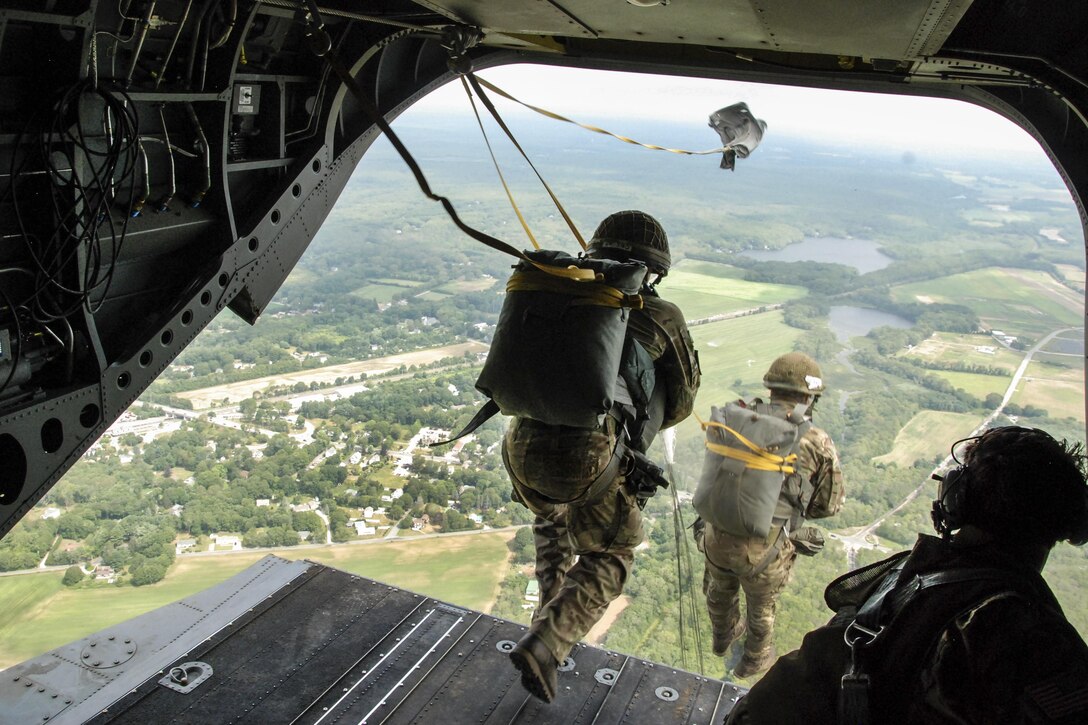 U.S. and partner nation paratroopers jump from a CH-47 F Chinook helicopter during Leapfest 2016, an international parachute training event, in West Kingston, R.I., Aug. 6, 2016. The Rhode Island Army National Guard's 56th Troop Command hosted the exercise to promote technical training and esprit de corps within the international airborne community. The helicopter is assigned to the New York Army National Guard. Army National Guard photo by Staff Sgt. Quentin Davis