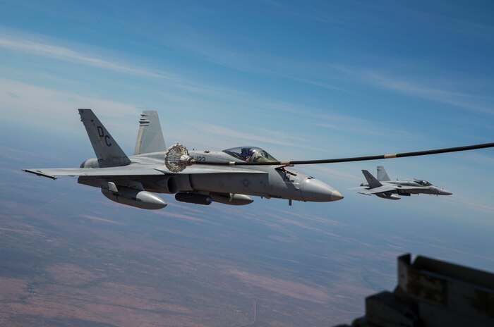 An F/A-18C Hornet with Marine Fighter Attack Squadron (VMFA) 122 moves in to catch the basket during an aerial refueling mission with Marine Aerial Refueler Transport Squadron (VMGR) 152 at Royal Australian Air Force Base Tindal, Australia during Exercise Pitch Black 2016, Aug. 9, 2016. VMGR-152 provides aerial refueling and assault support during expeditionary and joint or combined operations like Pitch Black. This exercise is a biennial, three week, multinational, large-force training exercise hosted by RAAF Tindal. (U.S. Marine Corps photo by Cpl. Nicole Zurbrugg)