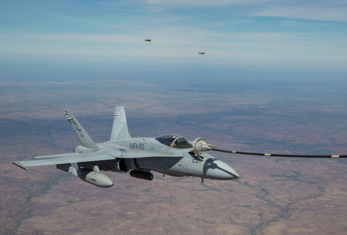 An F/A-18C Hornet with Marine Fighter Attack Squadron (VMFA) 122 conducts an aerial refueling with Marine Aerial Refueler Transport Squadron (VMGR) 152 during Exercise Pitch Black 2016 at Royal Australian Air Force Base Tindal, Australia, Aug. 9, 2016. VMGR-152 provides aerial refueling and assault support during expeditionary and joint or combined operations like Pitch Black. This exercise is a biennial, three week, multinational, large-force training exercise hosted by RAAF Tindal. (U.S. Marine Corps photo by Cpl. Nicole Zurbrugg)