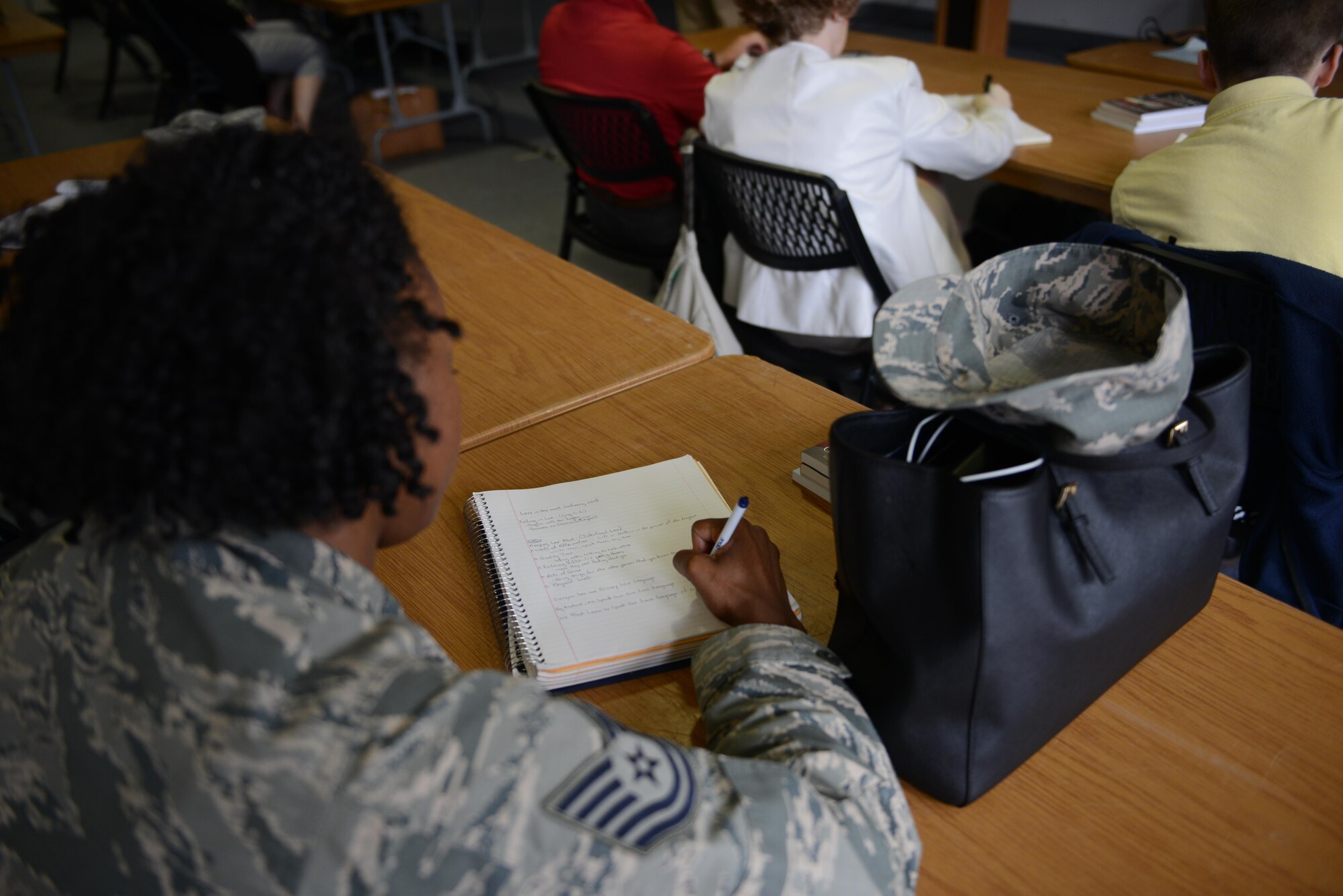 A participant takes notes during a marriage counseling workshop Aug. 5, 2016, at Ramstein Air Base, Germany. Members from helping agencies around the Kaiserslautern Military Community attended the workshop in order to enhance their ability to advise military members seeking marital advice. (U.S. Air Force photo/ Airman 1st Class Joshua Magbanua)
