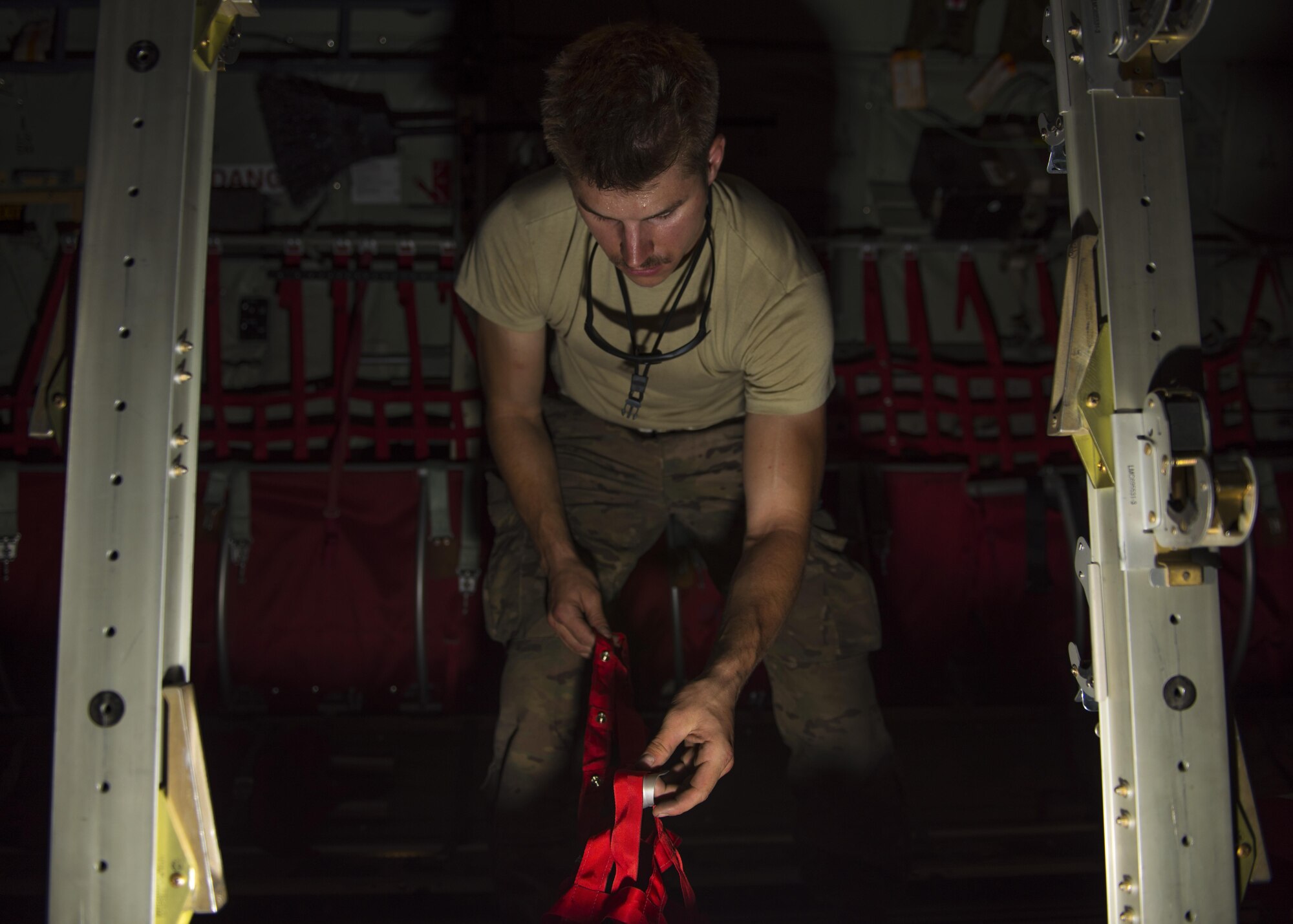 Senior Airman Christopher McEwen, 455th Expeditionary Aircraft Maintenance Squadron C-130J Super Hercules crew chief, reconfigures the inside of the aircraft for passenger travel, Bagram Airfield, Afghanistan, Aug. 8, 2016. Along with tactical airlift missions, the C130J is also used to transport passengers and cargo. (U.S. Air Force photo by Senior Airman Justyn M. Freeman)