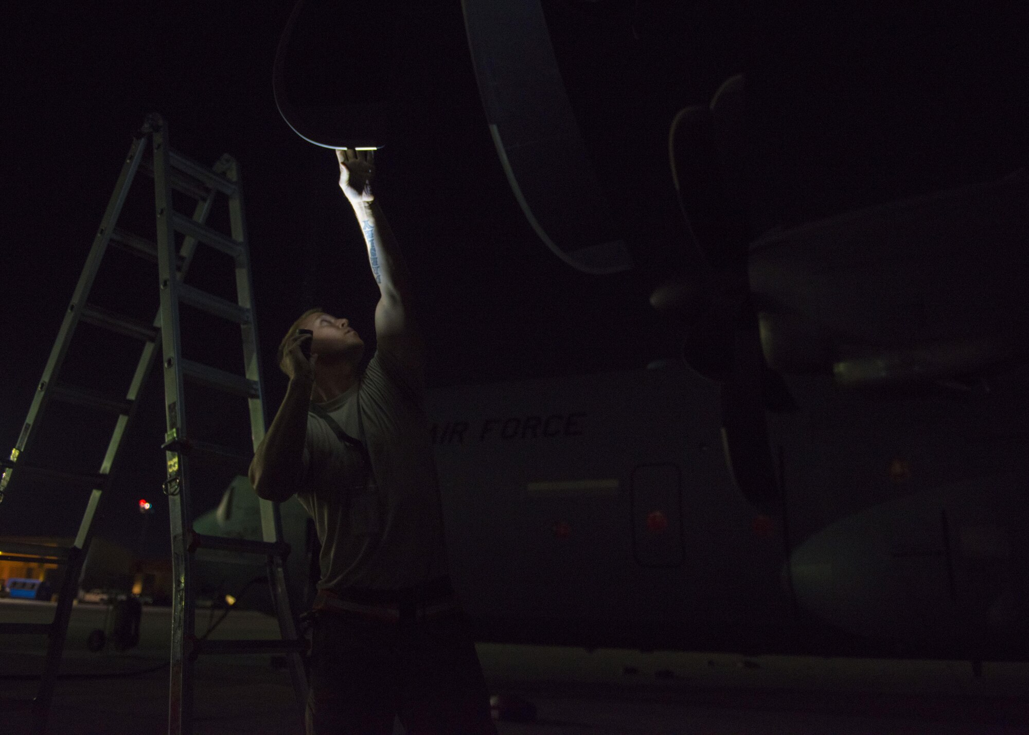 Staff Sgt. Joshua Jorgensen, 455th Expeditionary Aircraft Maintenance Squadron C-130J Super Hercules flying crew chief, checks propeller blades during a thru-flight inspection, Bagram Airfield, Afghanistan, Aug. 8, 2016. The nickel guard covering on the propeller blades are often checked for peeling or damage created by rocks and other debris. (U.S. Air Force photo by Senior Airman Justyn M. Freeman)