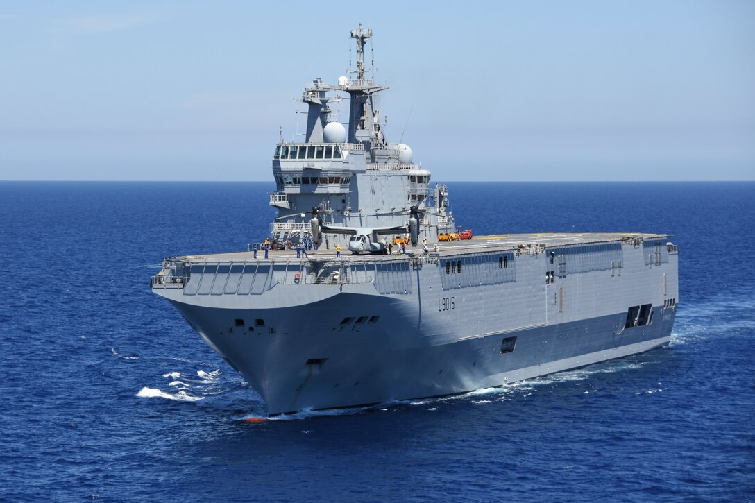 An MV-22B Osprey with Marine Medium Tiltrotor Squadron 266, Special Purpose Marine Air-Ground Task Force-Crisis Response-Africa, lands onboard the BPC Dixmude as part of bilateral training in the Gulf of Cadiz, Spain, Aug. 6, 2016. The Dixmude served as a platform to assist SPMAGTF-CR-AF in maintaining their readiness by hosting carrier qualification training. (Courtesy photo provided by Lt. Cmdr. Florian Edus) 
