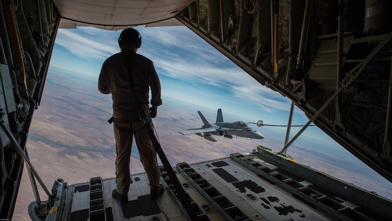 U.S. Marine Corps Cpl. Chris Lawler, a crewmaster with Marine Aerial Refueler Transport Squadron 152, observes an F/A-18C Hornet with Marine Fighter Attack Squadron 122 approach the refueling hose during Exercise Pitch Black 2016 at Royal Australian Air Force Base Tindal, Australia, Aug. 9, 2016. VMGR-152 provides aerial refueling and assault support during expeditionary, joint and combined operations like Pitch Black. This exercise is a biennial, three week, multinational, large-force training exercise hosted by RAAF Tindal. 