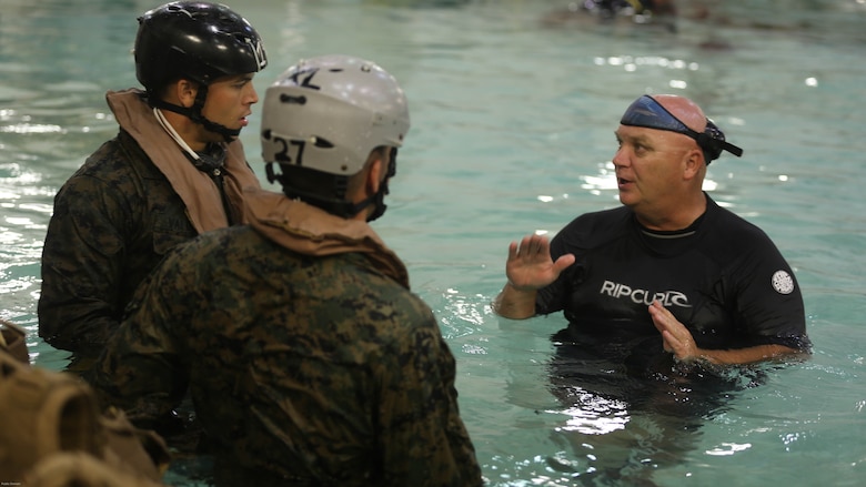 Glenn LaMarque an Under Water Trainer instructor briefs  Marines on the safety regulations and precautions they will need to understand to conduct a helo dunker training exercise at the Water Survival training facility on Marine Corps Base Camp Lejeune, N.C. Aug. 5, 2016. The Marines undertook the training which is designed as a lifesaving course that provides service members with the skills and confidence too successfully and safely egress out of a helicopter that has suffered a controlled or uncontrolled landing within a body of water. 