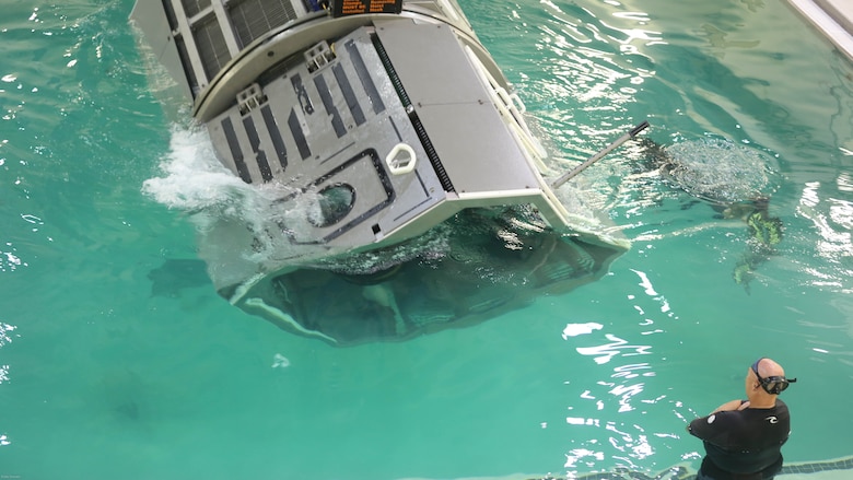 Marines with Combat Logistics Battalion 24 and instructors with the Water Survival training facility become completely submerged and begin to rotate in a Helo Dunker in order to emulate the scenario of a helicopter crash to help the Marines with the skills and confidence too successfully and safely egress out of a helicopter that has suffered a controlled or uncontrolled landing within a body of water at the Water Survival training facility on Marine Corps base Camp Lejeune, N.C. Aug. 5, 2016. The Marines undertook the training which is designed as a lifesaving course that provides service members with the skills and confidence too successfully and safely egress out of a helicopter that has suffered a controlled or uncontrolled landing within a body of water. 