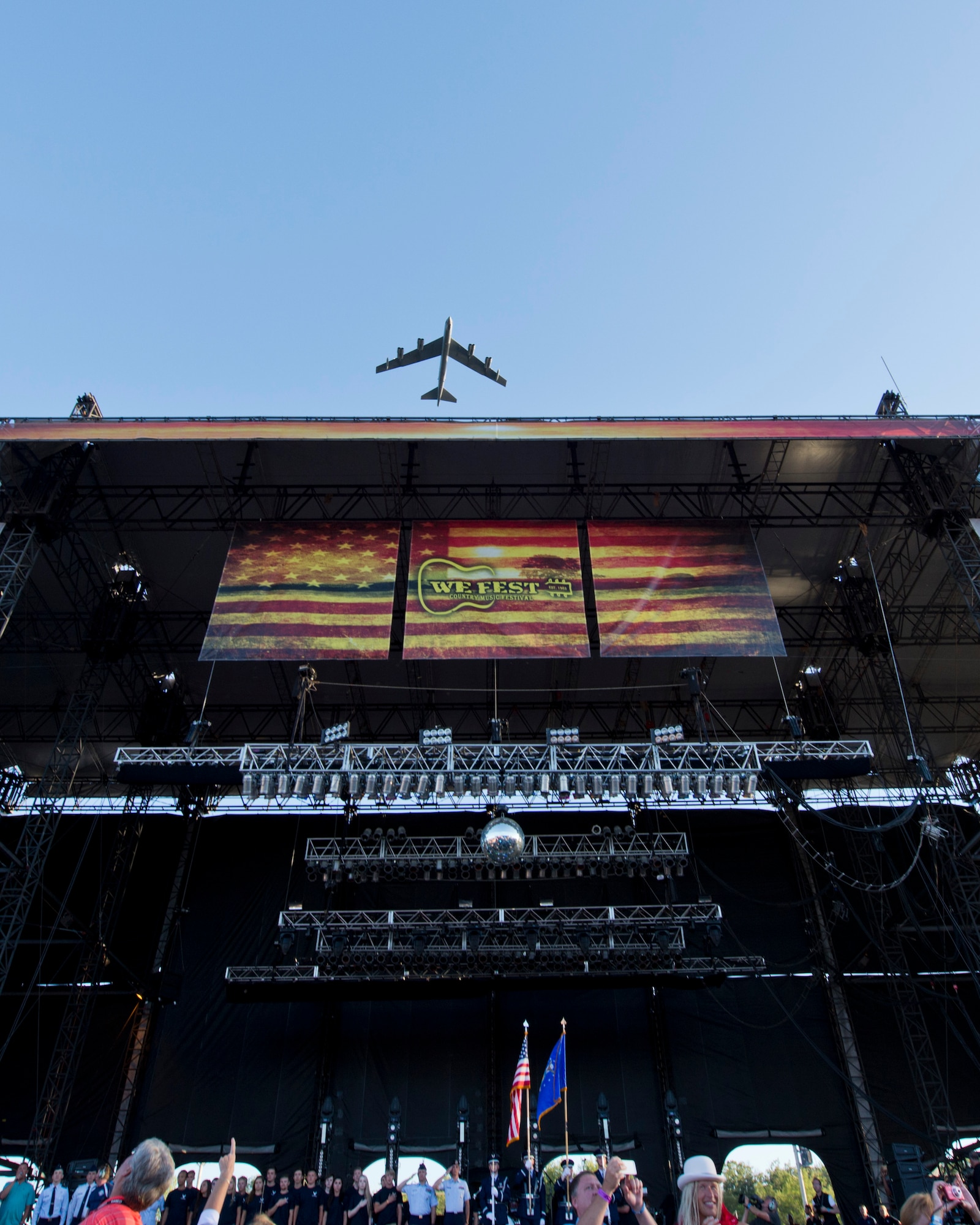 A B-52H Stratofortress from Minot Air Force Base, N.D., flies over the WE Fest concert stage in Detroit Lakes, Minn., Aug. 5, 2016. Seventeen members of the local Air Force Delayed Entry Program swore in during the music festival . For more than 40 years, the B-52 has been the backbone of the manned strategic bomber force for the U.S. (U.S. Air Force photo/Airman 1st Class J.T. Armstrong)