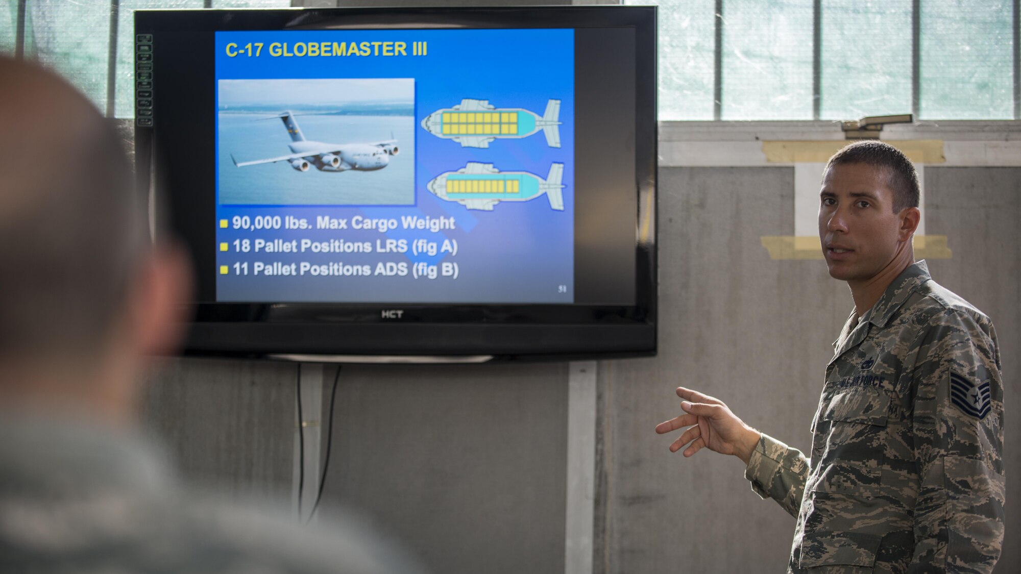 Tech. Sgt. Roy Townes, 31st Logistics Readiness Squadron NCO in charge of air operations, teaches 31st Maintenance Squadron Airmen on cargo preparation and pallet build-up training, Aug. 8, 2016, at Aviano Air Base, Italy. Townes instructed Airmen on how to properly assemble and disassemble cargo pallets. (U.S. Air Force photo by Airman 1st Class Cory W. Bush/Released)