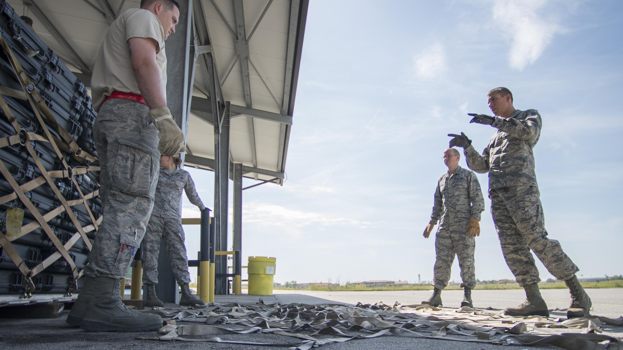 Tech. Sgt. Roy Townes, 31st Logistics Readiness Squadron NCO in charge of air operations, provides hands-on cargo preparation and pallet build-up training for 31st Maintenance Squadron Airmen, Aug. 8, 2016, at Aviano Air Base, Italy. Air transportation Airmen are responsible for ensuring an aircraft’s cargo and passengers are safely secured for transportation. (U.S. Air Force photo by Airman 1st Class Cory W. Bush/Released)