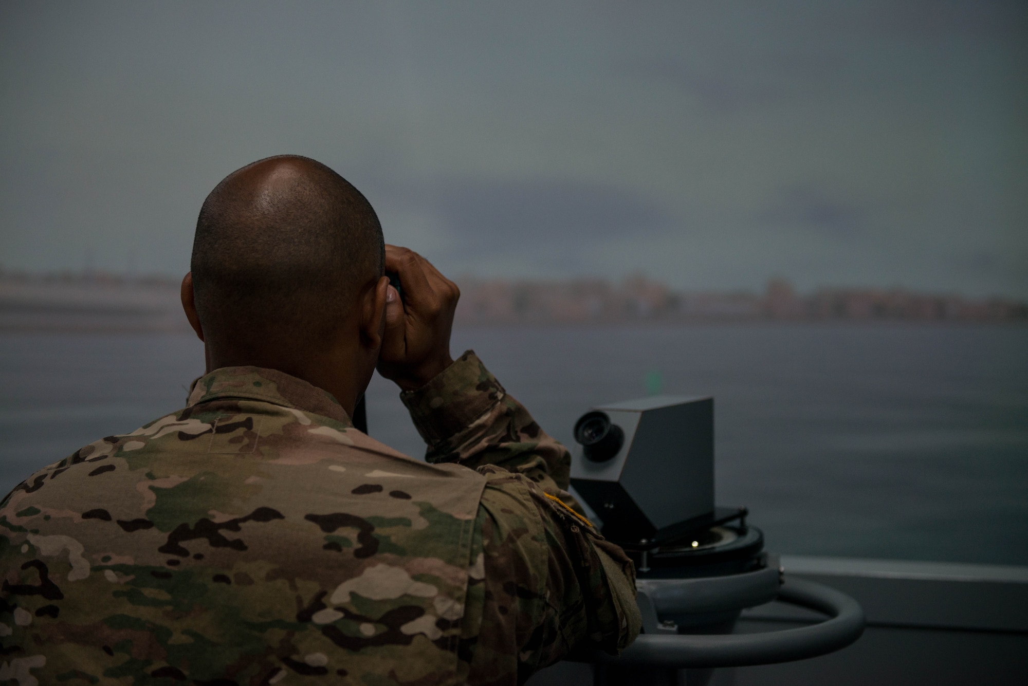 U.S. Army Spc. Antony Delgado, 203rd Transportation Detachment water craft operator, keeps watch during pre-deployment training at Fort Eustis, Va., Aug. 2, 2016. The person assigned as a lookout watches for hazards, other vessels in the water and possible dangerous watercraft coming towards the ship. (U.S. Air Force photo by Airman 1st Class Derek Seifert)