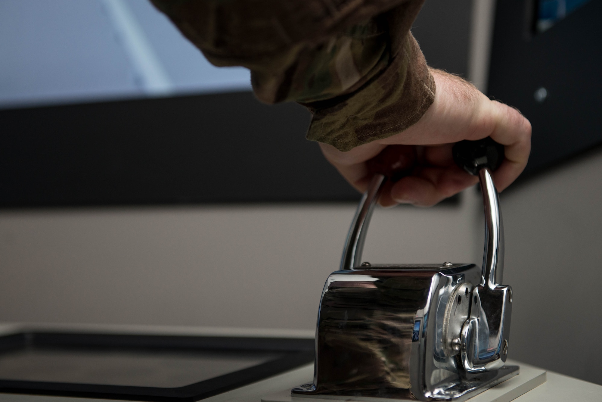A U.S. Army Soldier handles the throttle and thrust on a simulator during pre-deployment training at Fort Eustis, Va., Aug 2, 2016. The unit will be deploying with a large logistics supply vessel, but will be trained on different ships to be more proficient for a variety of missions. (U.S. Air Force photo by Airman 1st Class Derek Seifert) 