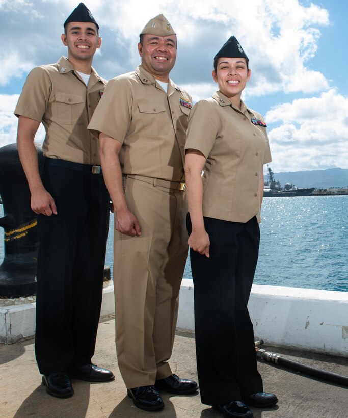 Navy Petty Officer 1st Class John Pacheco, left, Navy Lt. John Pacheco, center, and Navy Petty Officer 1st Class Christine Smith pose for a photo at Joint Base Pearl Harbor-Hickam, Hawaii, July 29, 2016, while serving together for the Rim of the Pacific maritime exercise.  Navy photo by Petty Officer 2nd Class Michael H. Lee
