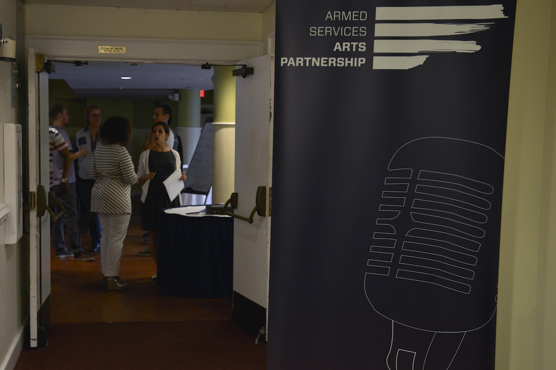 Members of Joint Base Langley-Eustis attend an Armed Services Arts Partnership comedy show at Fort Eustis, Va., August 5, 2016. The Armed Services Arts Partnership hosts a variety of arts classes for veterans who are struggling with issues ranging from post traumatic stress disorder to depression. (U.S. Air Force photo by Staff Sgt. Natasha Stannard)