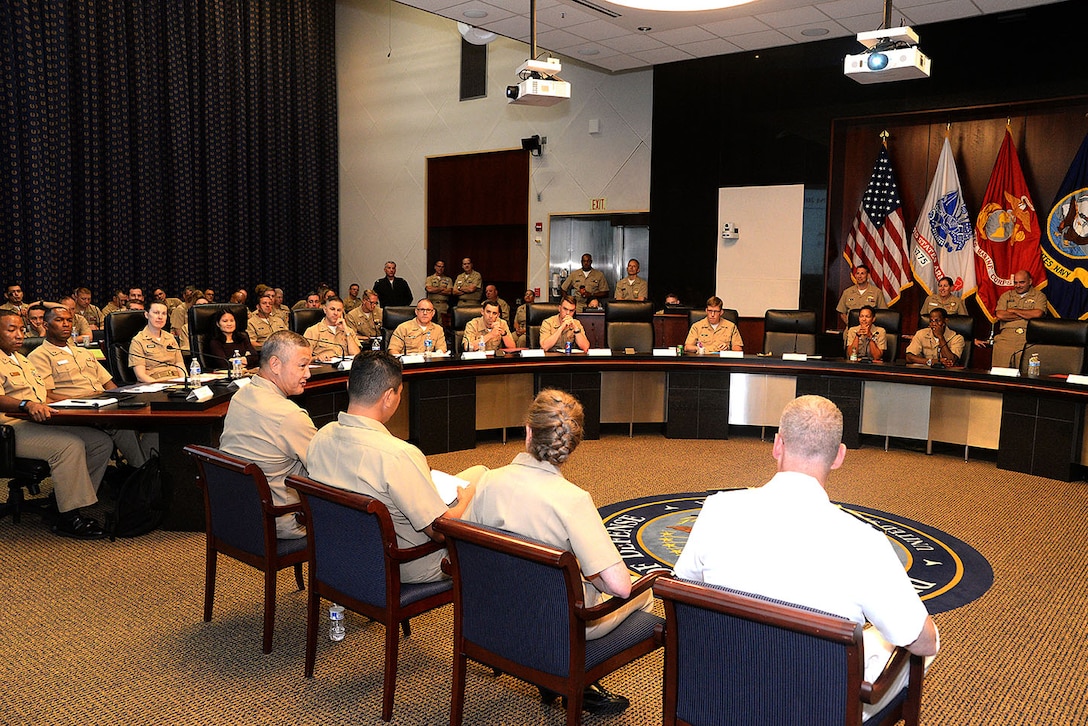 Participants of the Mid-Atlantic Norfolk Region Professional Development Symposium ask questions of their leadership Aug. 6 at Defense Logistics Agency Headquarters, Fort Belvoir, Virginia. The flag officer panel included Navy Rear Adm. Ron MacLaren, director of the DLA Joint Reserve Force; Navy Rear Adm. "Allie" Coetzee; Navy Rear Adm. "Chip" Chase Jr., Reserve director of Logistics Programs and Business Operations, Office of Chief of Naval Operations; and Navy Rear Adm. (Select) Alan Reyes, deputy chief of staff for Reserve Operations, NAVSUP Global Logistics Support.