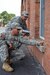 Army Reserve Maj. Mario Boemio, kneeling, checking the mortar around a historic building, while Sgt. 1st Class Jose Robinson writes down the data. (Photo Credit: John B. Snyder)