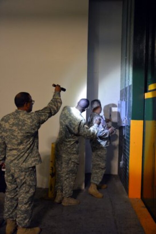 Sometime it takes a team as shown by the 305th Engineer Facility Detachment out of Staten Island, N.Y., to track down all the electrical panels in 72 arsenal buildings. (Photo Credit: John B. Snyder)