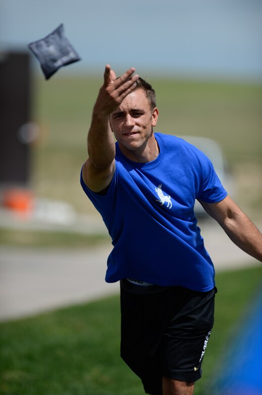 Michael Morris, 50th Space Wing, tosses a bean bag during the corn hole portion of the Tri-Wing Sports Day at Schriever Air Force Base, Colorado, Friday, Aug. 5, 2016. The 50 SW took third in corn hole, but won the overall title via tiebreaker over the 460th Space Wing. (U.S. Air Force photo/Christopher DeWitt)