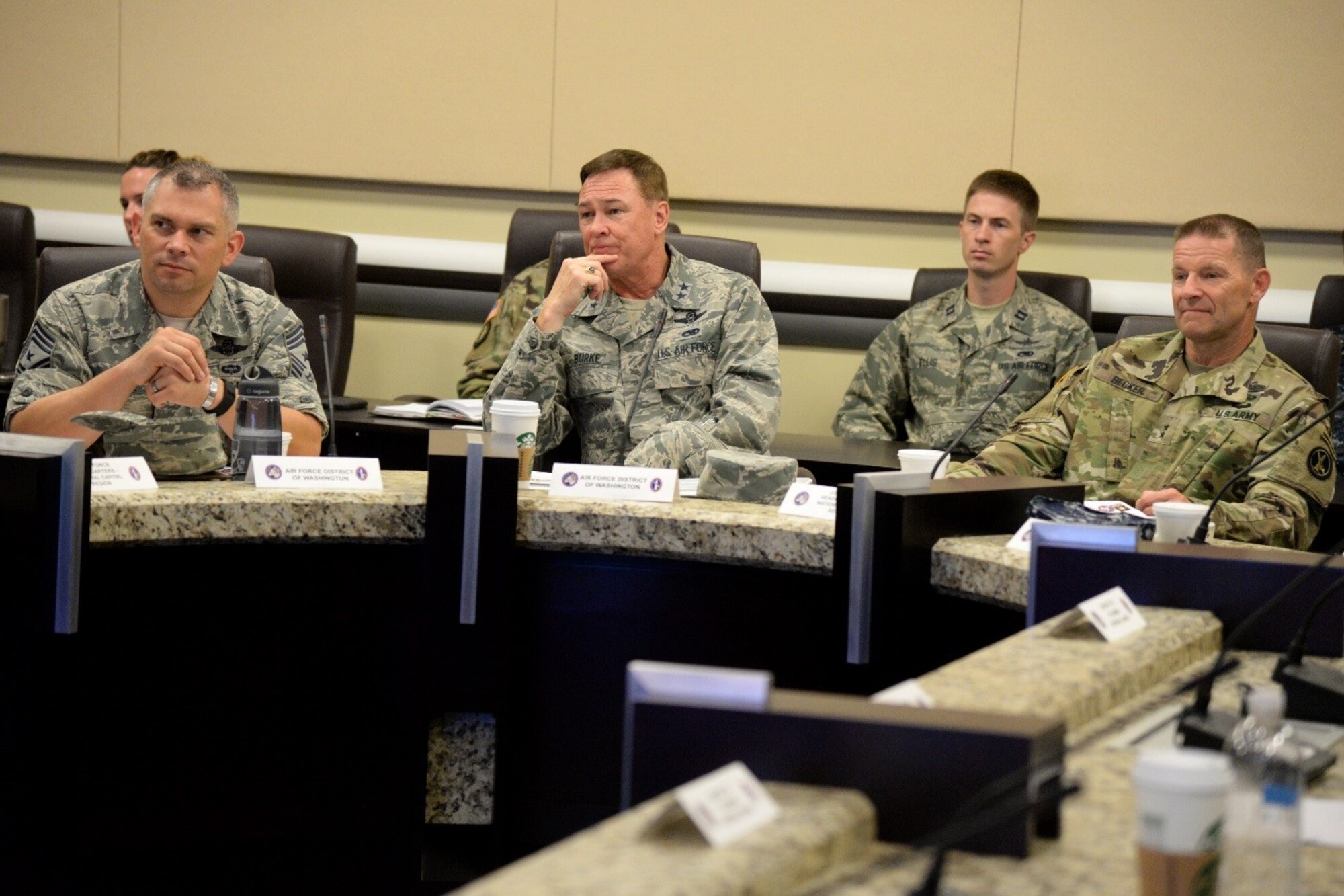 Chief Master Sgt. Tommy Mazzone, Air Force District of Washington command chief, Maj. Gen. Darryl Burke, AFDW commander and Maj. Gen. Bradley Becker, Joint Force Headquarters- National Capital Region Military District of Washington commander listen to a brief during the JFHQ-NCR Commander’s Conference on Joint Base Andrews Aug. 8, 2016. The conference provides an opportunity for JFHQ-NCR organizations to plan and coordinate joint support for national special security events within the region. (U.S. Air Force photo/Tech. Sgt. Matt Davis)
