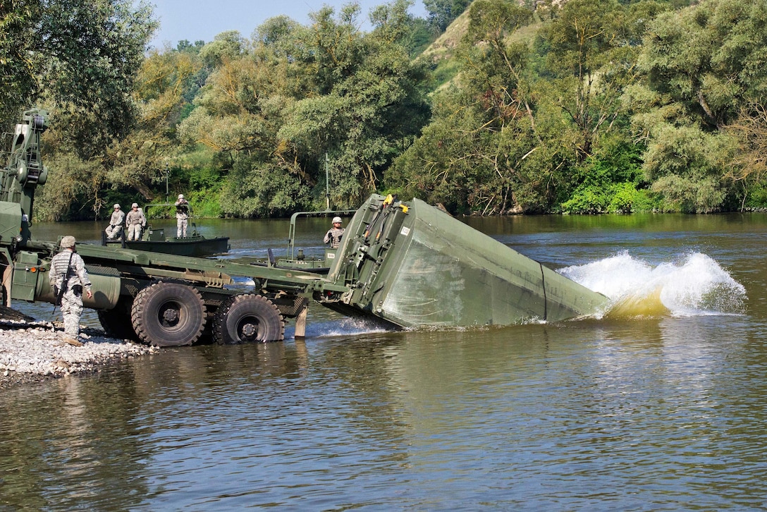 Soldiers immerse a portion of an improved ribbon bridge into the Olt River near Voila, Romania, during Exercise Saber Guardian 16,  Aug. 1, 2016. Army photo by Capt. John Farmer