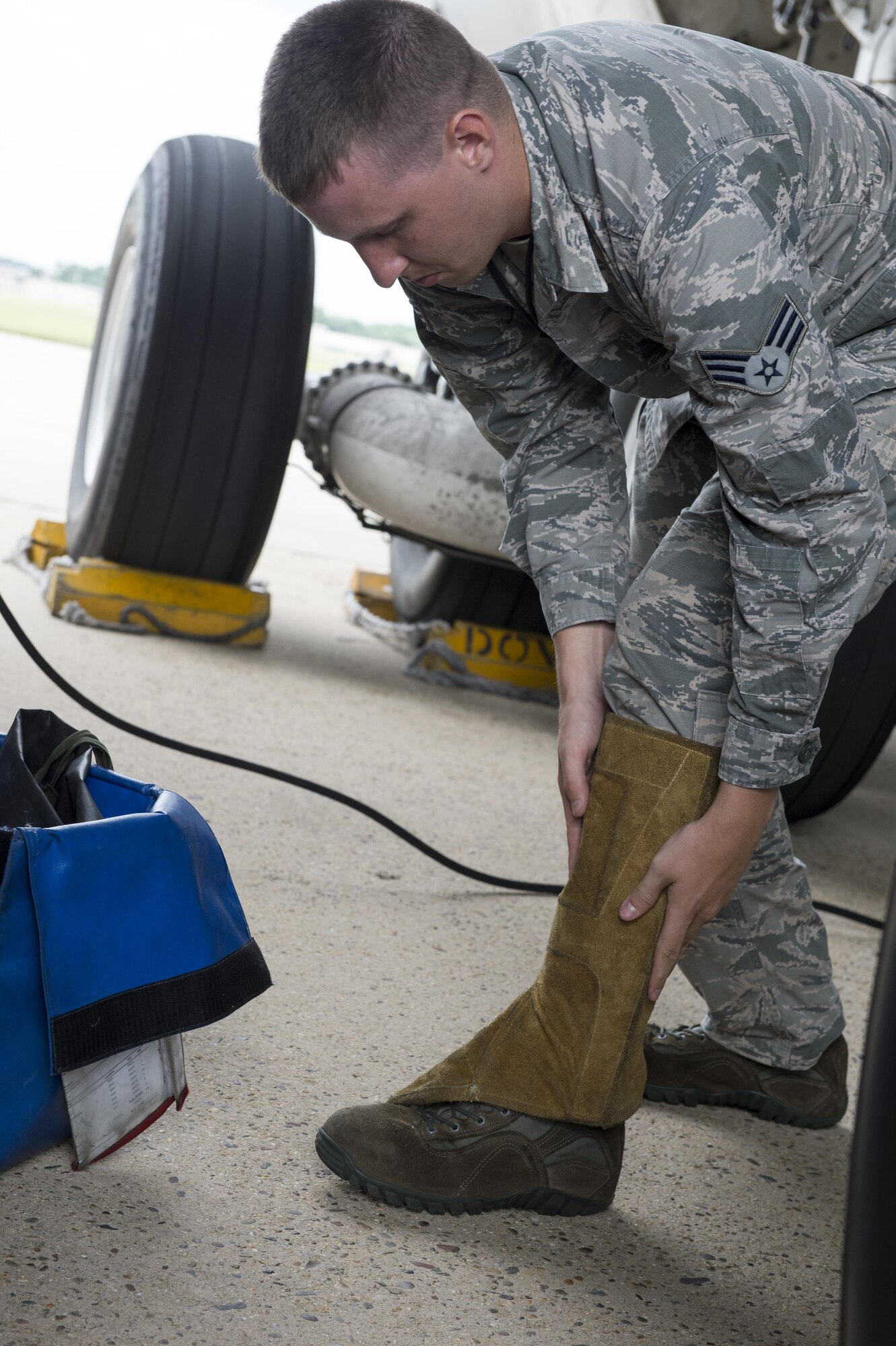 A 436th Maintenance Squadron maintainer from Dover Air Force Base, Del., puts on protective equipment as he prepares to service a C-5 Super Galaxy with compressed hydrogen Aug. 2, 2016, Joint Base McGuire-Dix-Lakehurst, NJ. More than 150 Airmen went TDY to JB MDL after parts of the Dover AFB runway closed for reconstruction. (U.S. Air Force Photo/ Staff Sgt. Tiffany Lindemann)