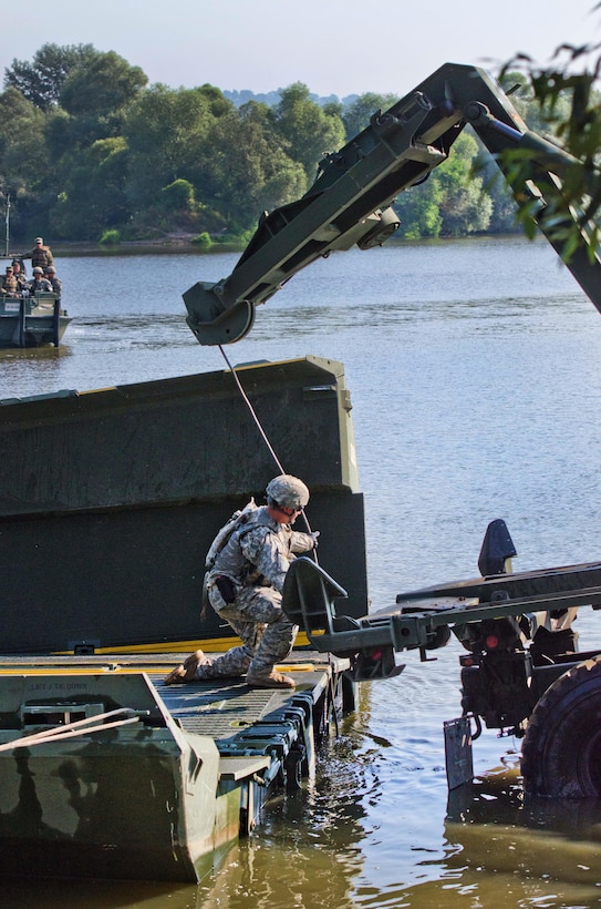 A soldier releases a cable from an improved ribbon bridge on the Olt River near Voila, Romania, during Exercise Saber Guardian 16, Aug. 1, 2016. Army photo by Capt. John Farmer