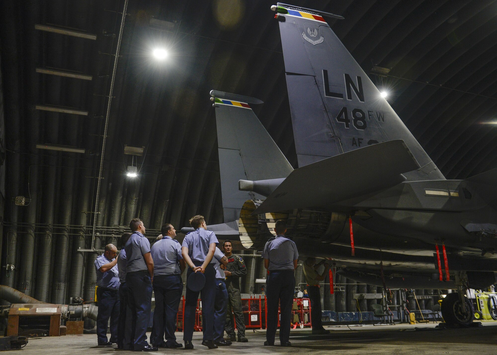 Royal Air Force Coningsby airmen look at an F-15E Strike Eagle at RAF Lakenheath, England, Aug. 9. The airmen toured the base after giving a similar tour to RAF Lakenheath Airmen a few weeks prior. (U.S. Air Force photo by Airman 1st Class Abby L. Finkel) 